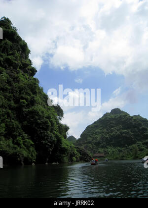 NINH BINH, VIETNAM, JULY, 20: Unidentified tourists in Trang An  on JULY, 20, 2013. Trang An is the scenic area, ranked special of Vietnam. Stock Photo