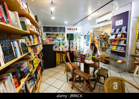 Two Customers seated at a table in the Whileaway Bookshop Café in Port Douglas, Far North Queensland, FNQ, QLD, Australia Stock Photo