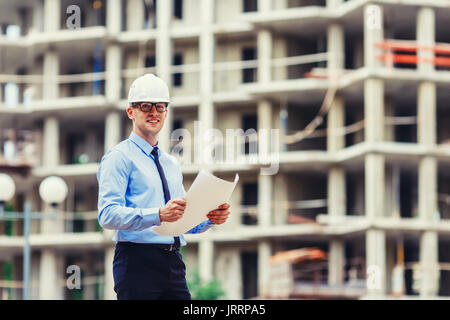 Handsom construction engineer at the construction site looking at the camera Stock Photo