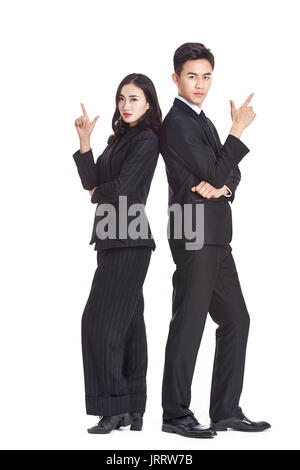 portrait of young asian businessman and businesswoman in formal businesswear showing hand sign of gun, isolated on white background. Stock Photo