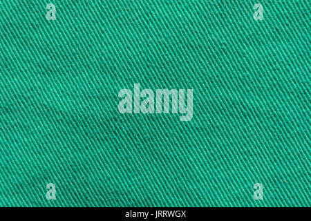 Green Denim Textile Texture Close-up. Macro Snapshot of Tissue Structure Stock Photo