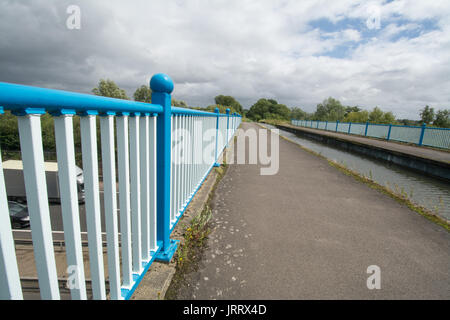 View of Ash Aqueduct on the Basingstoke Canal in Surrey, UK, with traffic on the A331 dual carriageway below Stock Photo