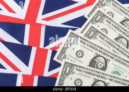 US $1 banknotes / bills with Union Jack.  US Dollar exchange rate concept, US economy, US UK exports, US UK balance of payments. Stock Photo