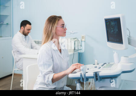 Cheerful young researchers are working in lab. Stock Photo