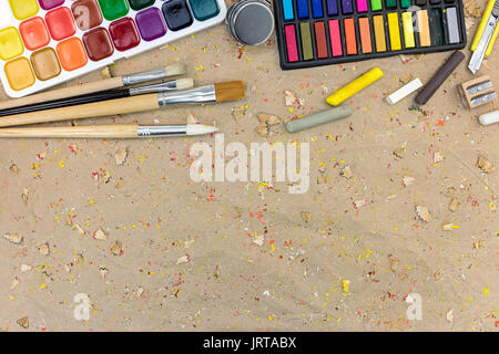 watercolor palette with paintbrushes different size and colorful pastels. colorful drawing supplies on desk. Stock Photo