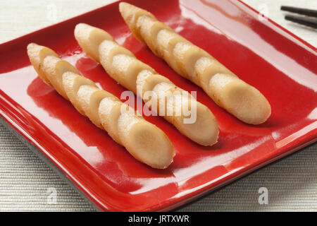 Dish with sliced Japanese pickled burdock roots called gobo Stock Photo