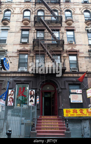 Building facades with fire escapes in China Town, New York City, USA. Stock Photo