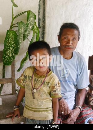 Close up of the humble King of the Boti tribe and his young nephew in islolated autonomous traditional village near Oinasi in West Timor, Indonesia Stock Photo