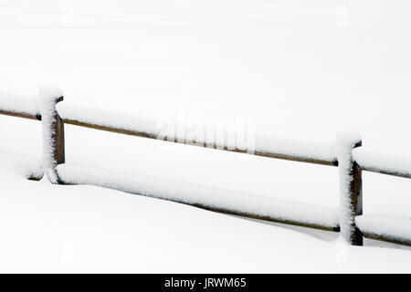 Snow covered wooden fence Stock Photo