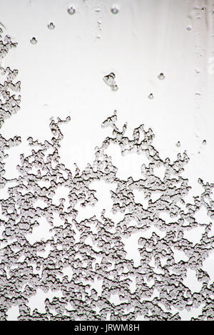 Ice crystals on a window creating an abstract pattern Stock Photo