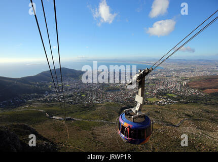 A view of a cable car making its way up to the peak of Table Mountain via cableway at Table Mountain National Park in Cape Town Stock Photo