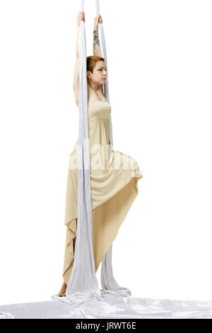Authentic young woman dancing with aerial silks in dress Stock Photo