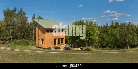 Eco-friendly, wood-house at the woods. Energy saving. Living in nature. Wooden building Stock Photo