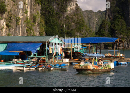 Boat woman vendor in Halong Bay, Vietnam.  Drink snack hat vendor rowing boat Halong Bay Vietnam. Stock Photo