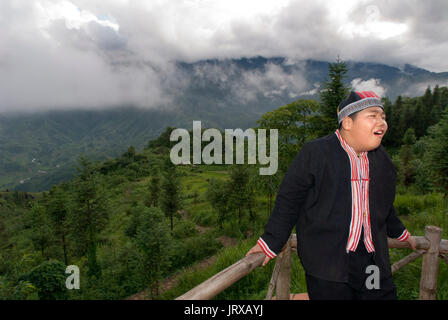 Vietnamese boy taking pictures in the balcony of the Green Valley in Sapa near the tower. Stock Photo