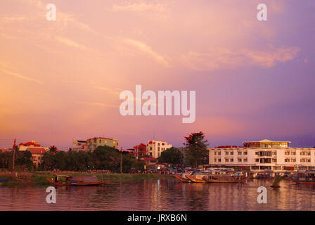 Dragon boat cuises at sunset on the river Huong (Perfume River). Vietnam. Dragon head and excursion boat, Song Huong or Huong Giang or Perfume River,  Stock Photo