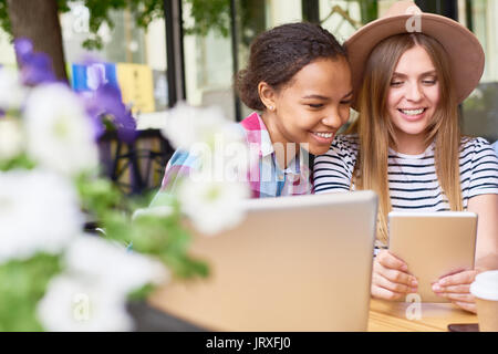 Beautiful Young Girls Using tablet in Cafe Stock Photo