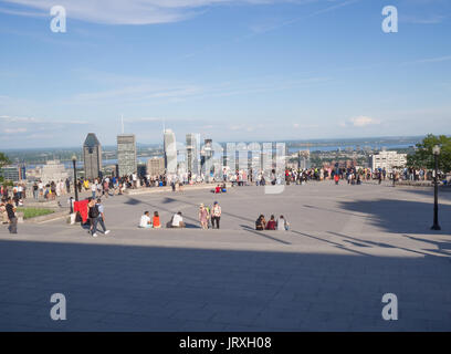 Tourists enjoying the view of downtown Montreal, Quebec City, Canada skyline from an overlook during daytime in summer Stock Photo