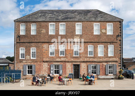 People sitting outside the Old Low Light Heritage Centre, North Shields, England, UK Stock Photo