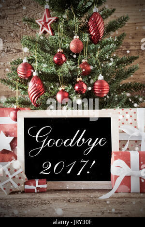 Nostalgic Christmas Card For Seasons Greetings. Christmas Tree With Balls. Gifts Or Presents In The Front Of Wooden Background. Chalkboard With Englis Stock Photo