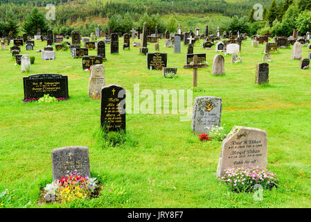 Uvdal, Norway - July 31, 2017: Travel documentary of the Uvdal cemetery with headstones and crosses. Forest in background. Stock Photo