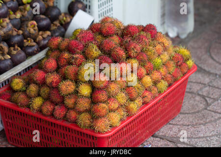rambutan fruit in box for sale on market Stock Photo