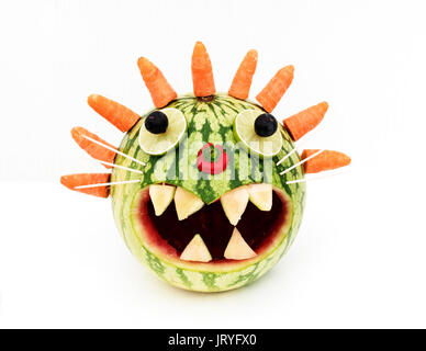 a melon made into a head and face using fruit and vegetables Stock Photo
