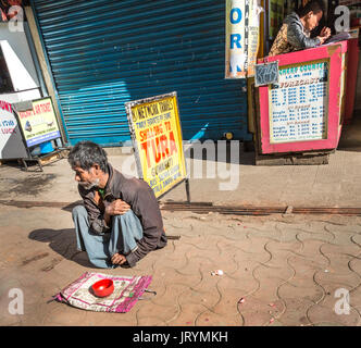 Begging in street in front of betting office, Shillong, Meghalaya, India Stock Photo