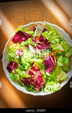 Mixed leaves salad - greens with radicchio salad and grated carrot Stock Photo
