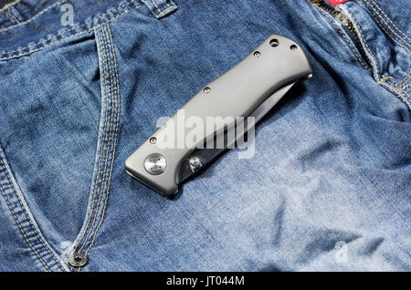 Folding knife with an aluminum handle in the folded form. Front side. Stock Photo
