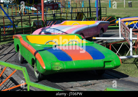 carousel with colorful cars stopped in the park Stock Photo