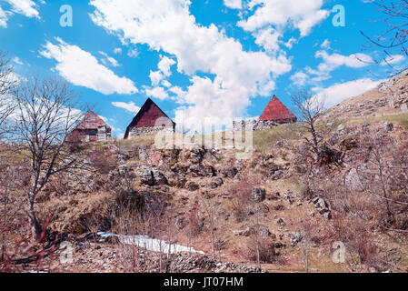 Traditional Old wooden hut in mountains of Bosnia and Herzegovina. The Village is Gradina and used as pasture in the summer for sheep. Mount Treskavic Stock Photo