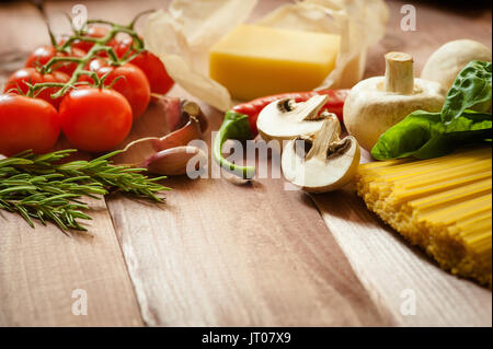 Pasta spaghetti with tomatoes, cheese and basil on rustic wooden background Stock Photo
