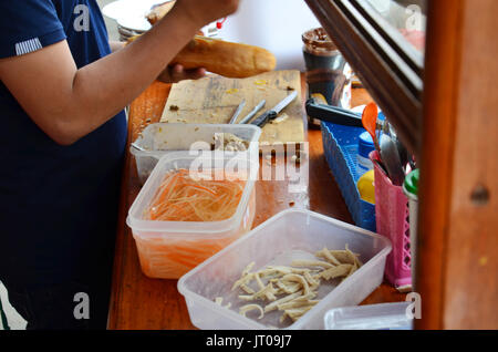 Laotian people cooking Khao Jee Sandwich or Baguette Sandwich is a famous street food for sale in morning at local restaurant in Pakse, Champasak, Lao Stock Photo