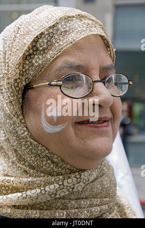 A woman with the Pakistani flag symbols painted on her cheek at the annual Pakistan Day Parade ion Midown Manhattan, New York City. Stock Photo