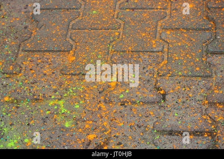 Multi-colored earth, paving slabs, powder coated with dry colors at the Holi festival in Gatchina, Russia Stock Photo