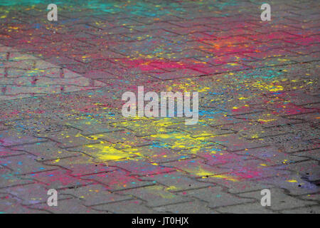 Multi-colored earth, paving slabs, powder coated with dry colors at the Holi festival in Gatchina, Russia Stock Photo