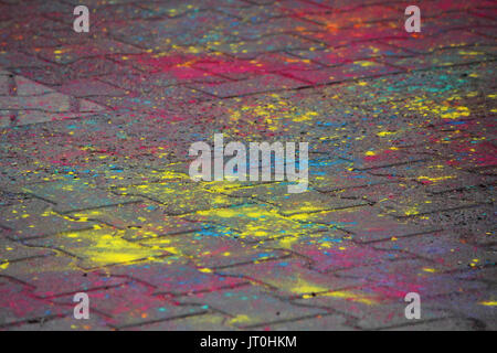 Multi-colored earth, paving slabs, powder coated with dry colors at the Holi festival in Gatchina, Russia Stock Photo
