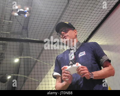 New York City, USA. 2nd Aug, 2017. Roman Aracelio controls the drone 'Infinity NX' manufactured by Odyssey in the exhibition 'Drones: Is the Sky the limit?' at the ntrepid Sea, Air and Space Museum in New York City, USA, 2 August 2017. Photo: Johannes Schmitt-Tegge/dpa/Alamy Live News Stock Photo