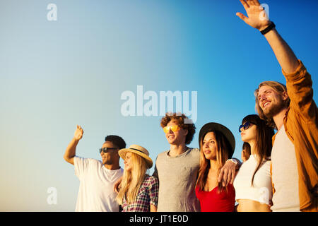 Group of happy friends having fun at ocean beach Stock Photo