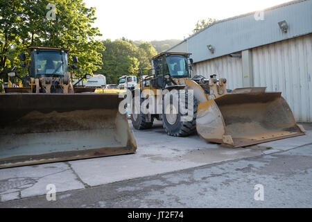 6th August 2017 - Large front end loader shovels parked up at the weekend Stock Photo