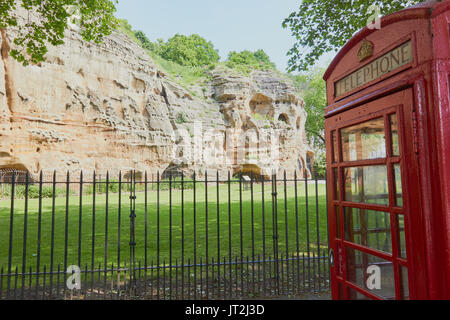 Caves beneath Castle Rock and original red British telephone box, Nottingham, Nottinghamshire, east Midlands, England Stock Photo