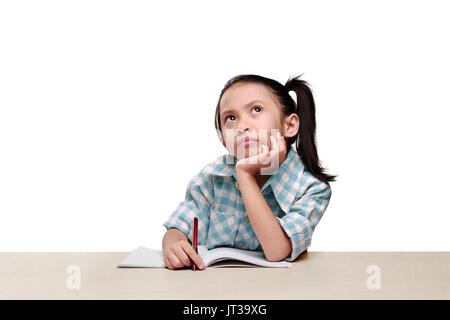 Portrait asian little girl holding pen and thinking isolated over white background Stock Photo