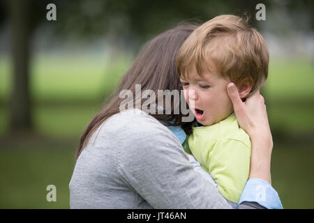 Sad little boy being hugged by his mother. Parenthood, Love and togetherness concept. Stock Photo