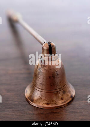 Old brass and wood candle snuffer Stock Photo