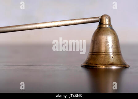 Old brass and wood candle snuffer Stock Photo