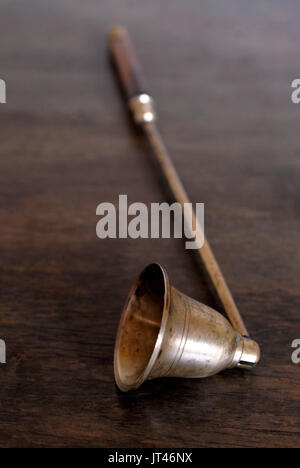 Old brass and wood candle snuffer Stock Photo