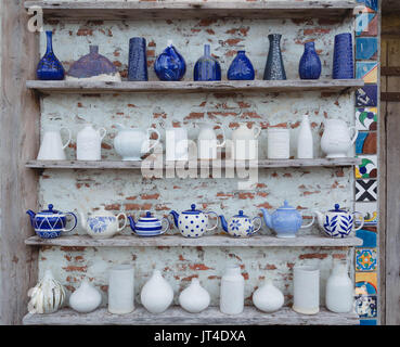 Ceramic vases are placed on shelves next to walls to decorate the house. Stock Photo