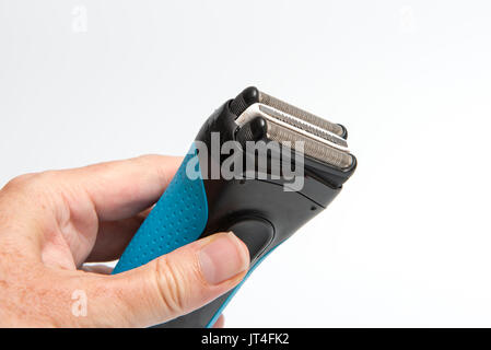 Hand holding an electric razor Stock Photo