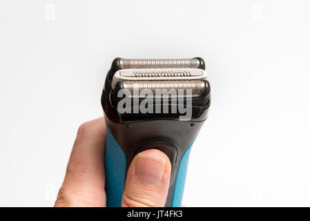 Hand holding a modern electric razor Stock Photo